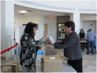 Elizabeth Barriga gives out free showerheads to Gallup Utility customers